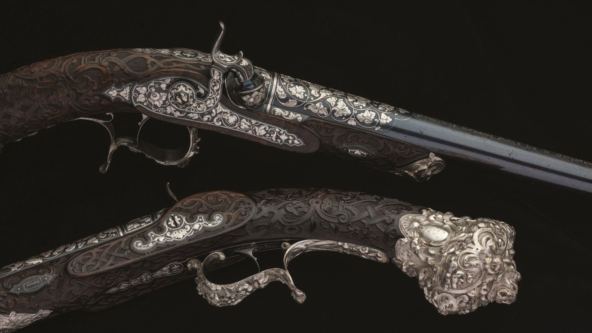 Elaborate Pair of Gastinne-Renette Percussion Pistols with Sculpted Silver Mounts and Relief Carved Stocks from the Exposition Universelle of 1855