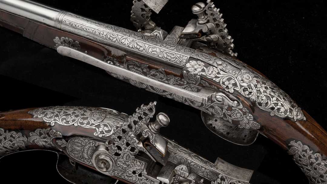 A-desirable-pair-of-chiseled--engraved--and-pierced-Italian-snaphance-belt-pistols