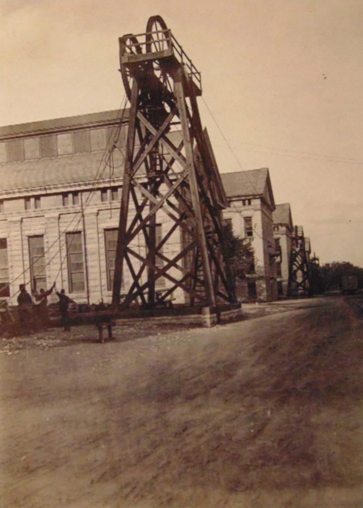 In this photo, workmen can be seen attaching the cables that would eventually transfer power into the shops.