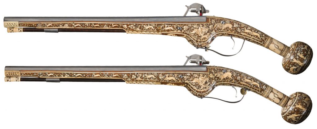pair of wheellock mechanism pistols with extensive scrimshaw inlays