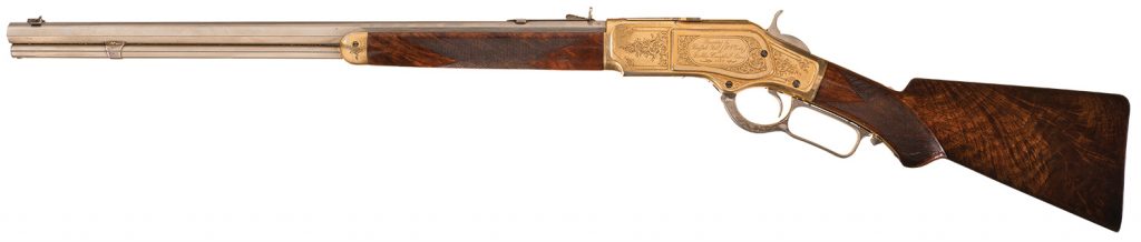 Historic and Well Documented John Ulrich Signed Factory Engraved Deluxe Winchester Model 1873 Lever Action Short Rifle with Factory Exhibition Special Order Finish and Features Presented by Buffalo Bill (William F. Cody) to Robbie Campbell Adams Twelve Year Old Son of Wild West Show Pamphlets Publisher for the Wild West Shows Performance at Madison Square Garden
