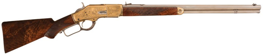 Lot 1036: Historic and Well Documented John Ulrich Signed Factory Engraved Deluxe Winchester Model 1873 Lever Action Short Rifle with Factory Exhibition Special Order Finish and Features Presented by Buffalo Bill (William F. Cody) to Robbie Campbell Adams Twelve Year Old Son of Wild West Show. Sold September 2016 for $345,000.