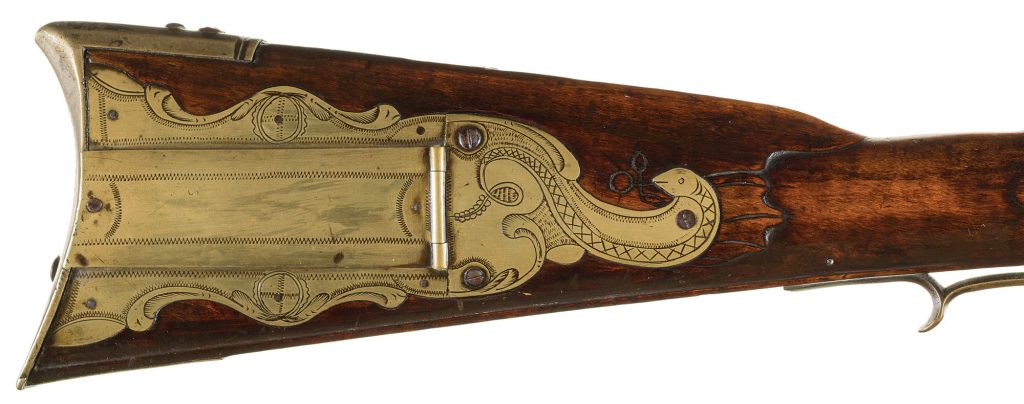 Another rattlesnake on the patchbox. This time on a documented Golden Age flintlock by George Schreyer. The other side of the stock features handsome raised carving. Formerly of the Joe Kindig, Jr. Collection.