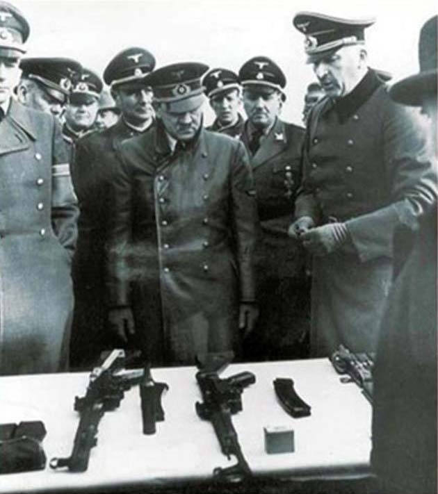  Hitler and his Minister of Armaments Albert Speer looking at weapons.