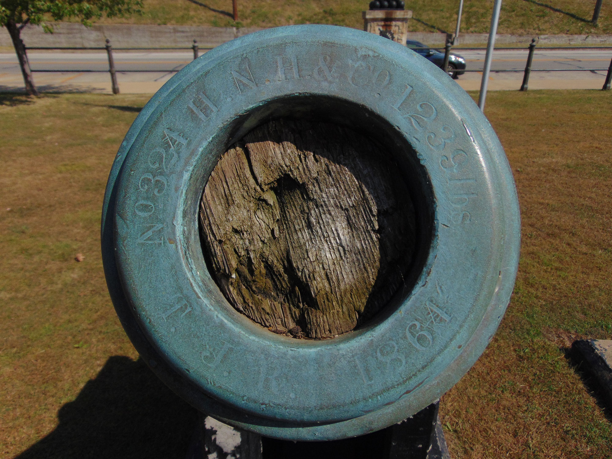 Photo of the Eastmost cannon and taken with lower f-stop to clarify the text on the muzzle which reads, "No. 324 H.N.H & Co 1239 lbs" and "T.J.R. 1864" H.N.H. & Co. stands for manufacturer Henry N. Hooper of Boston, MA.Photo of the Eastmost cannon and taken with lower f-stop to clarify the text on the muzzle which reads, "No. 324 H.N.H & Co 1239 lbs" and "T.J.R. 1864" H.N.H. & Co. stands for manufacturer Henry N. Hooper of Boston, MA.