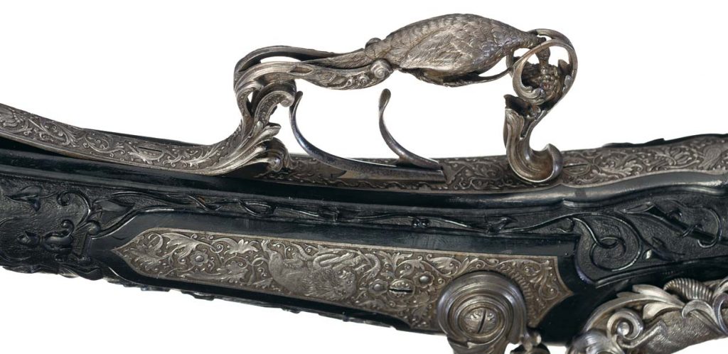 The trigger guard with a another carved animal, this time a pheasant eating grapes