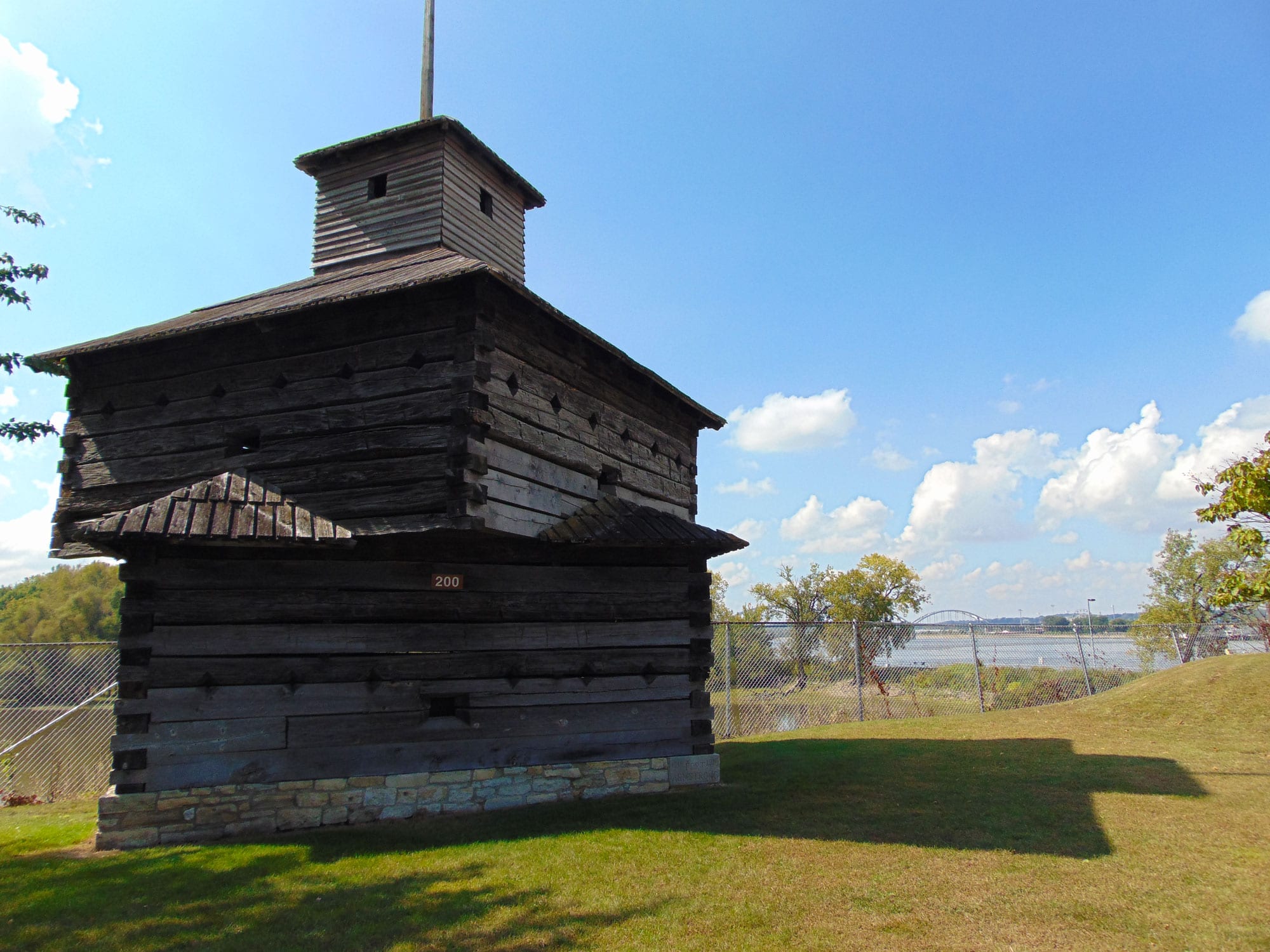 Cannons rest pointed at the Mississippi adjacent to a replica blockhouse constructed in 1916 to commemorate Fort Armstrong's centennial anniversary.